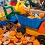 a toy truck filled with orange peels in a bin